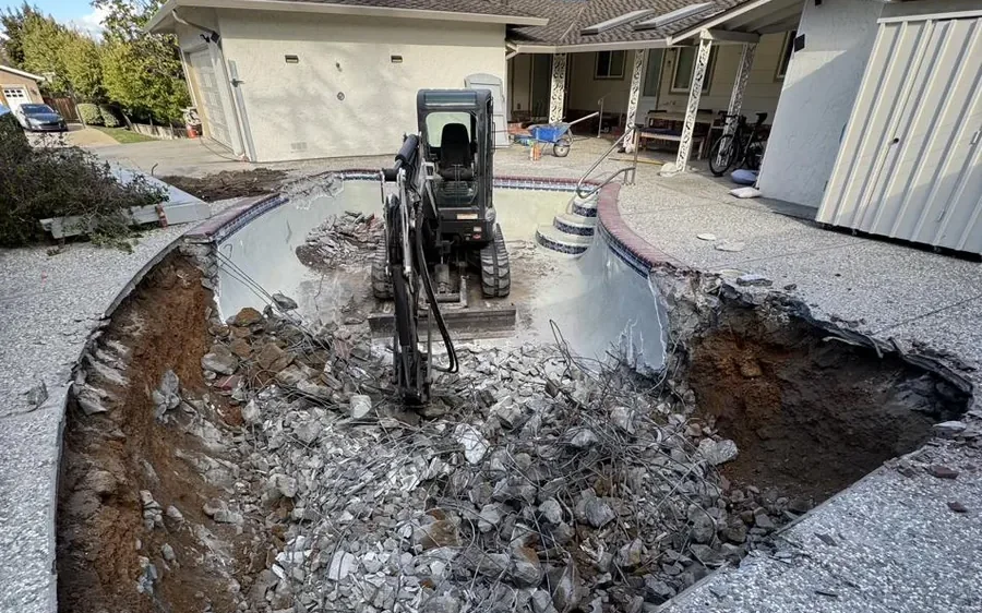 Pool excavation and demolition with an excavator on site